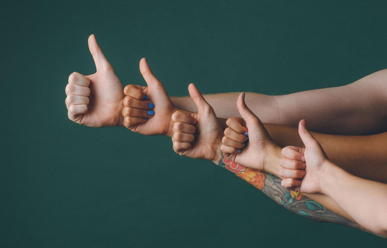 people giving a thumbs up sign, each positioned slightly higher than the one below to create a cascading effect
