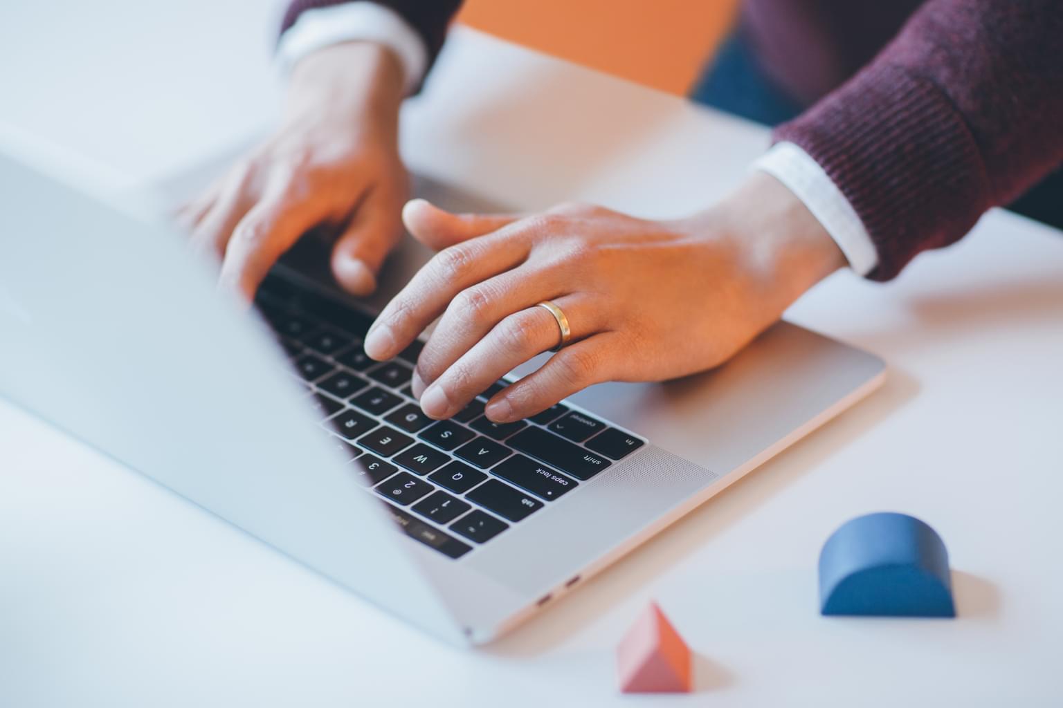 Salesperson typing on a laptop